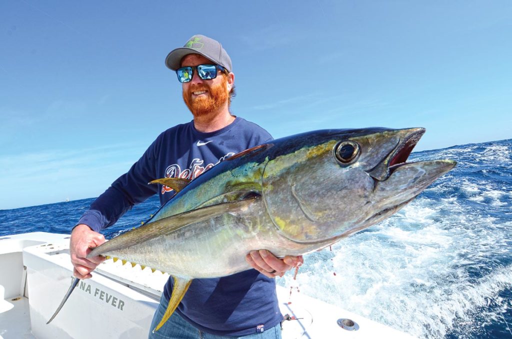 Showing off a huge yellowfin tuna catch.